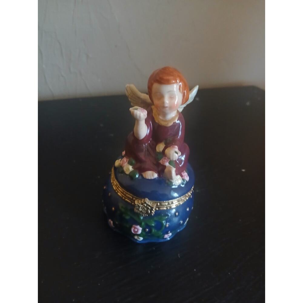 Beautiful Porcelain Angel holding flowers Trinket Box.